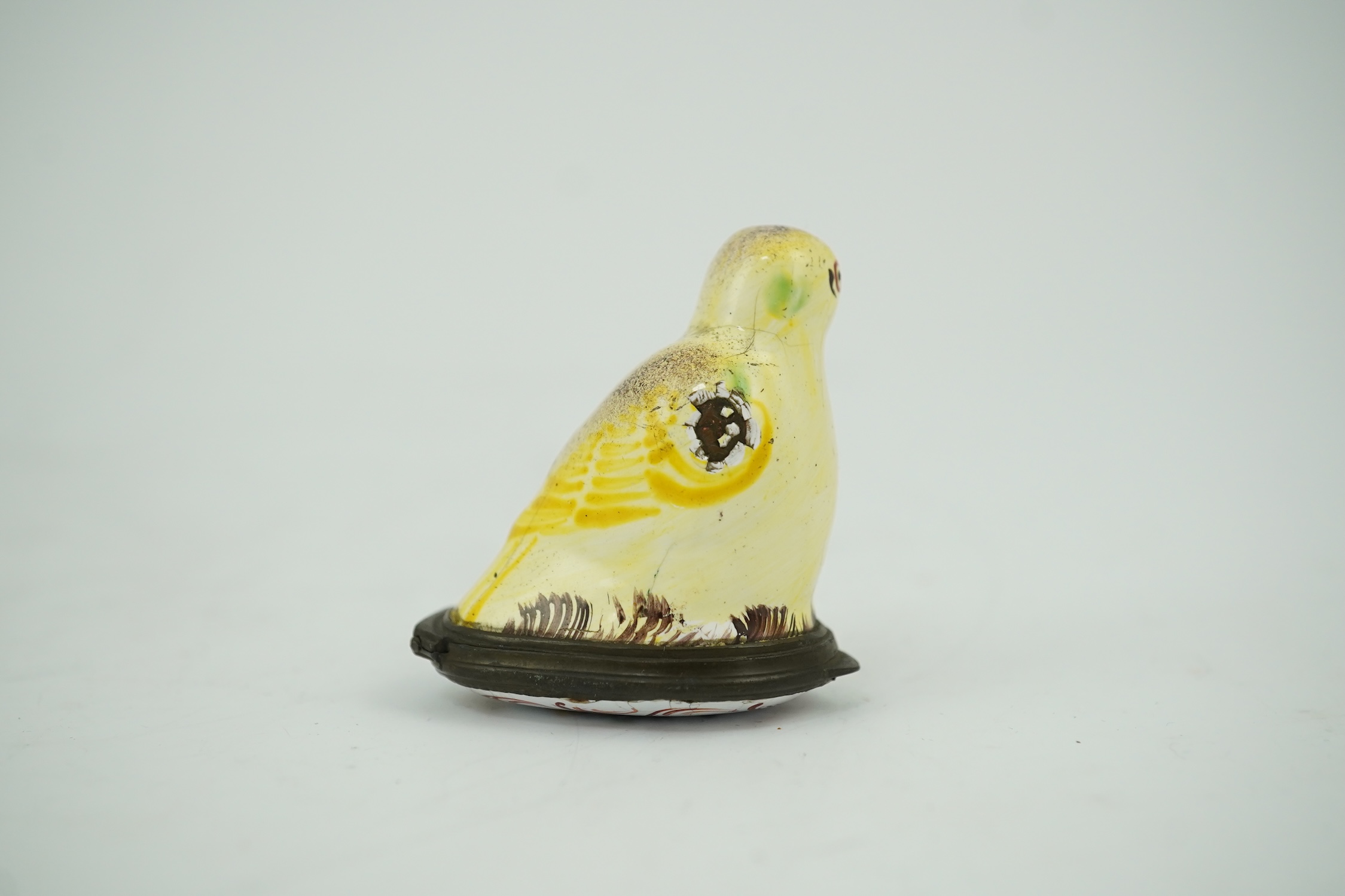 An 18th century South Staffordshire (Bilston) enamel box modelled as a canary with floral decorated lid, 4.5cm high. Condition - fair/poor